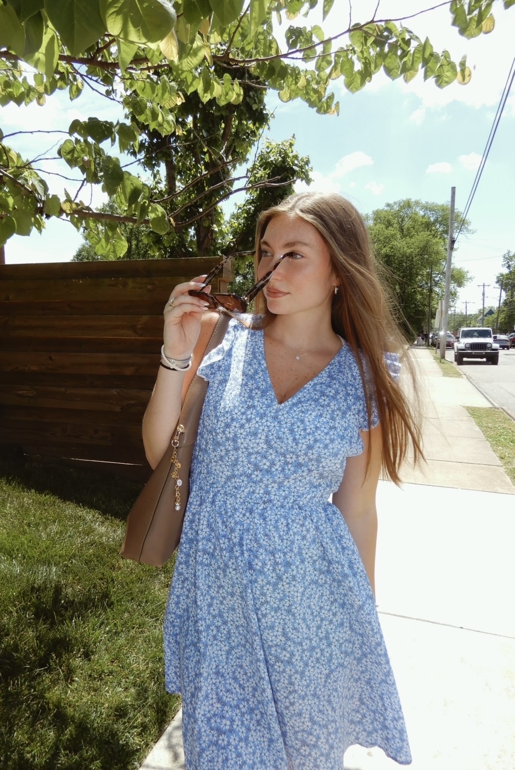 Brantley Adams outdoors in a blue floral dress